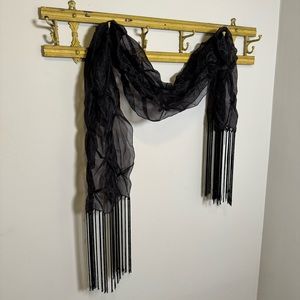 Sheer black wrap with long fringe, pinch pleats